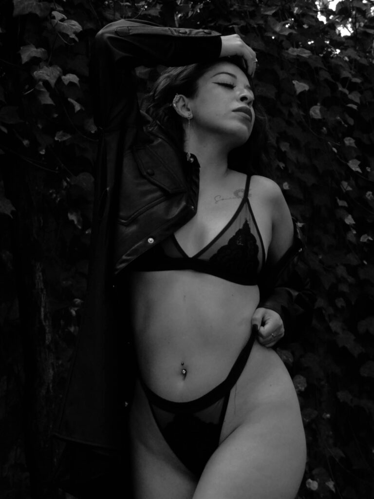 pexels-photo-29725371-29725371 Black and white photo of a woman in lingerie against foliage, outdoors and moody.